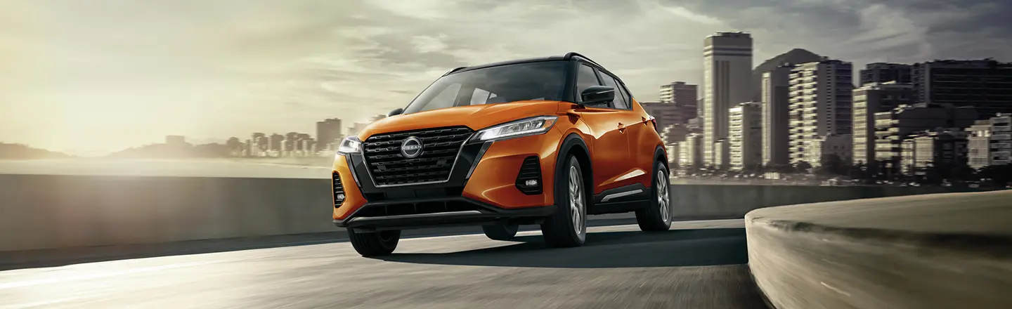 Front view of a 2023 Nissan Kicks driving on the highway.