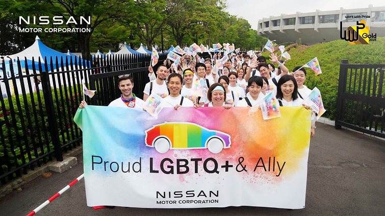 Nissan employees parade with rainbow-colored "Proud LGBTQ+& Ally" banner