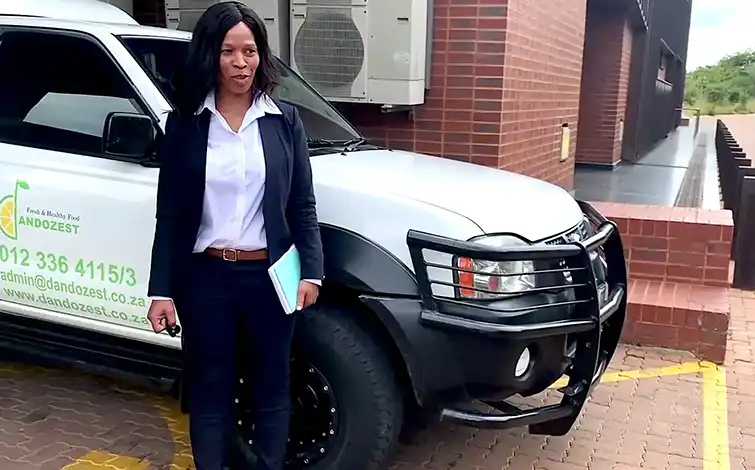 Nontuthuko Constance Shandu posing for a photo in front of a truck