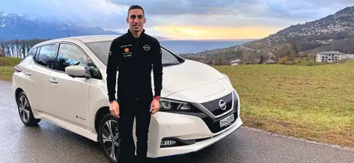 Sébastien Buemi standing in front of white vehicle