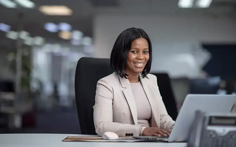 Mmathapelo Khumalo sitting at a desk posing for a photo