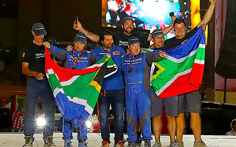 Group of people posing with South African flags