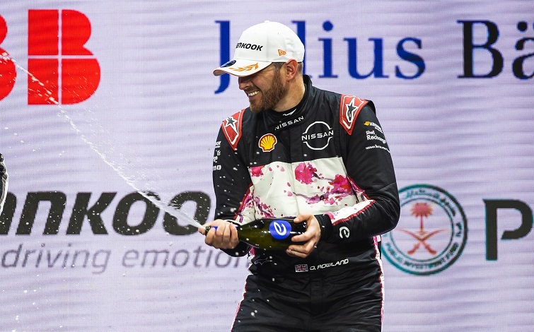 Oli spraying champagne on the podium