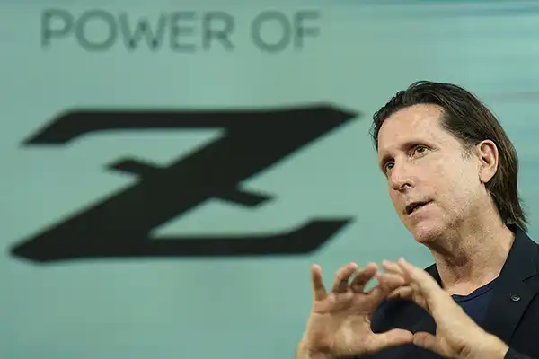 A portrait of Alfonso Albaisa in front of a background that says "Power of Z".