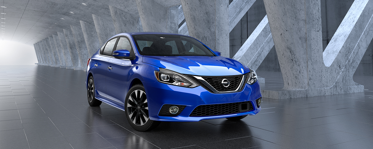 Blue Nissan Sentra parked near concrete pillars