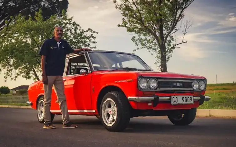 Superfan Warren Adams poses with his Datsun