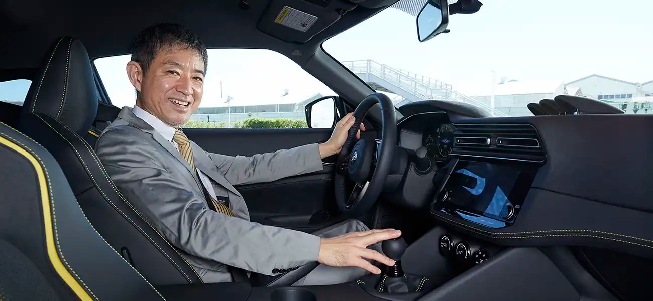 Hiroshi Tamura sitting in the driver seat of a Nissan Z.