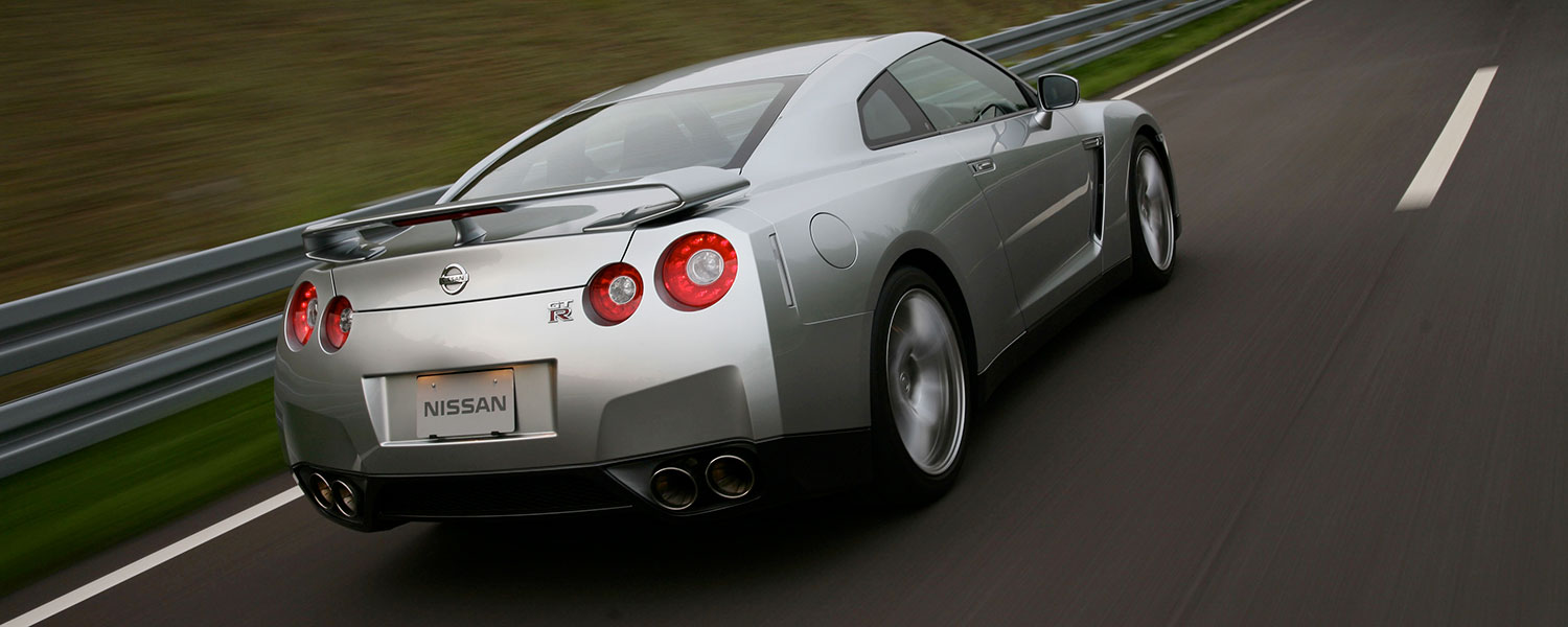 A silver Nissan GT-R driving on a road