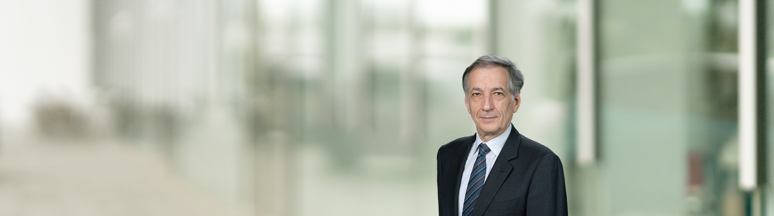 Portrait of Bernard Delmas (suit, tie and NISSAN corporate pin)