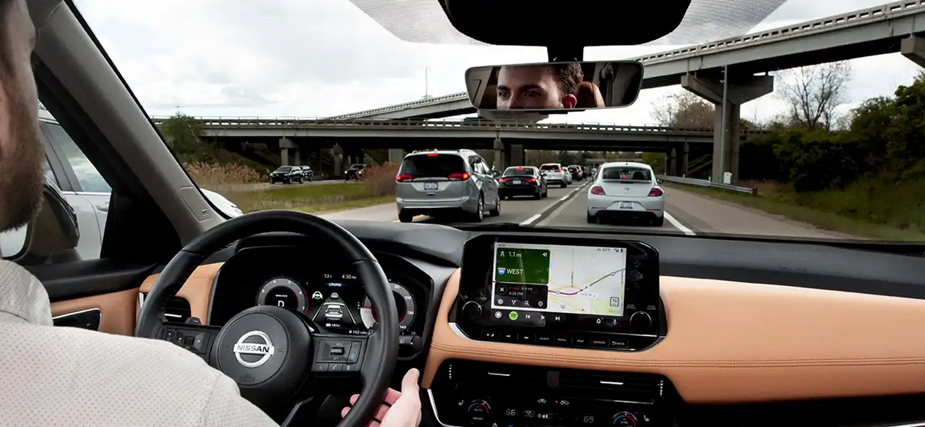 Tyler Szymkowski behind the wheel on a freeway.