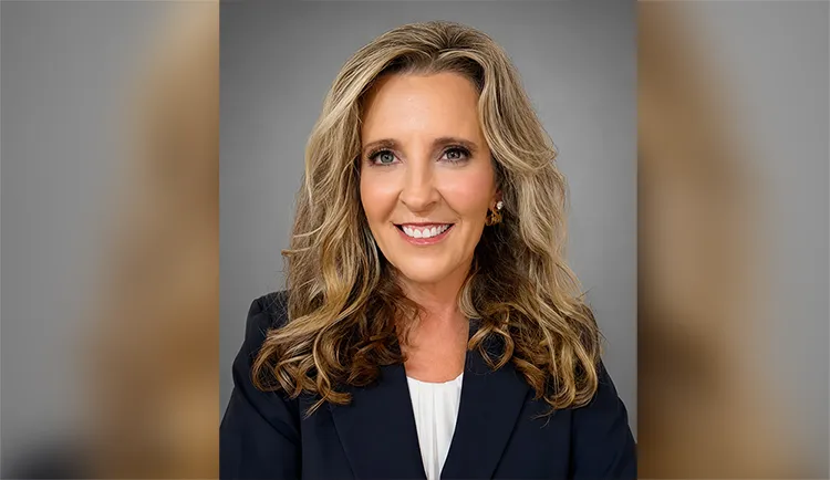 Headshot of Ashley Gatlin smiling against grey background