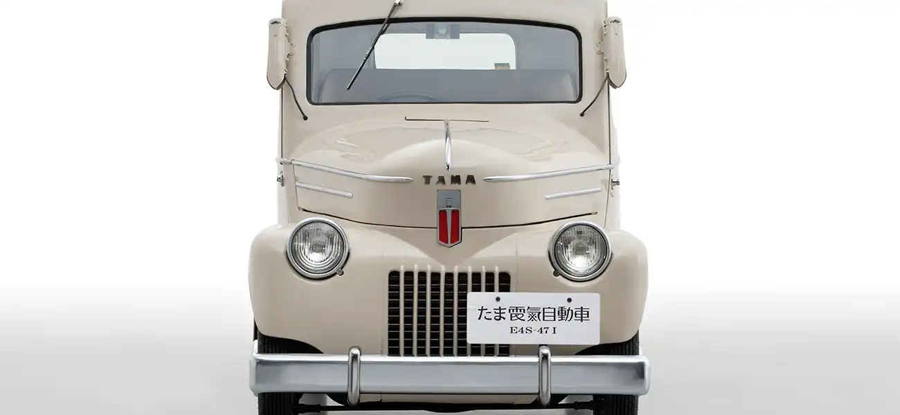 A white Tama parked in a white room.
