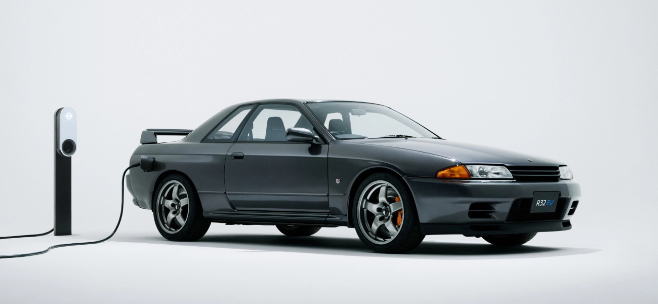 R32 GT-R EV charging in front of a white backdrop