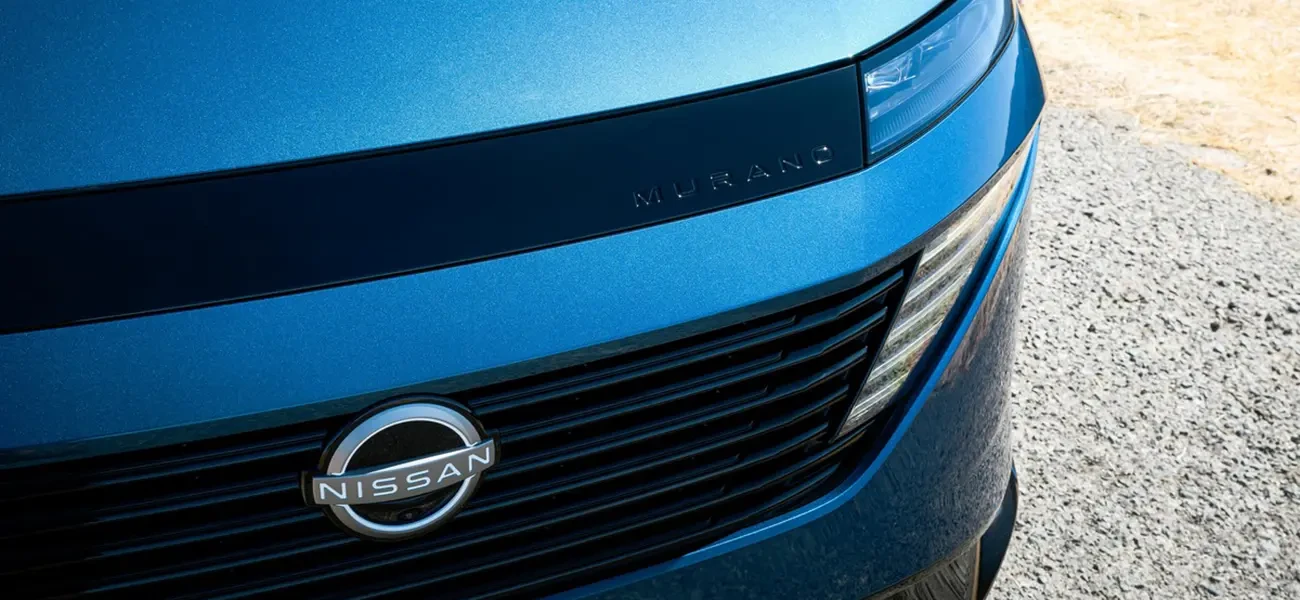 The front right corner of the 2025 Nissan Murano with gravel in the background