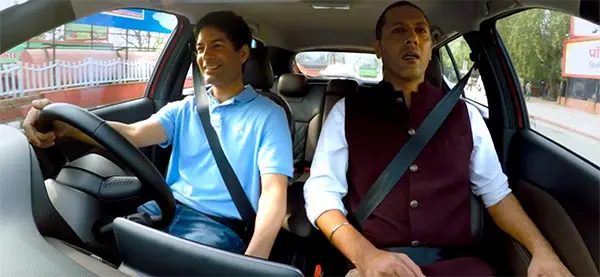 Two men driving the Nissan KICKS in town
