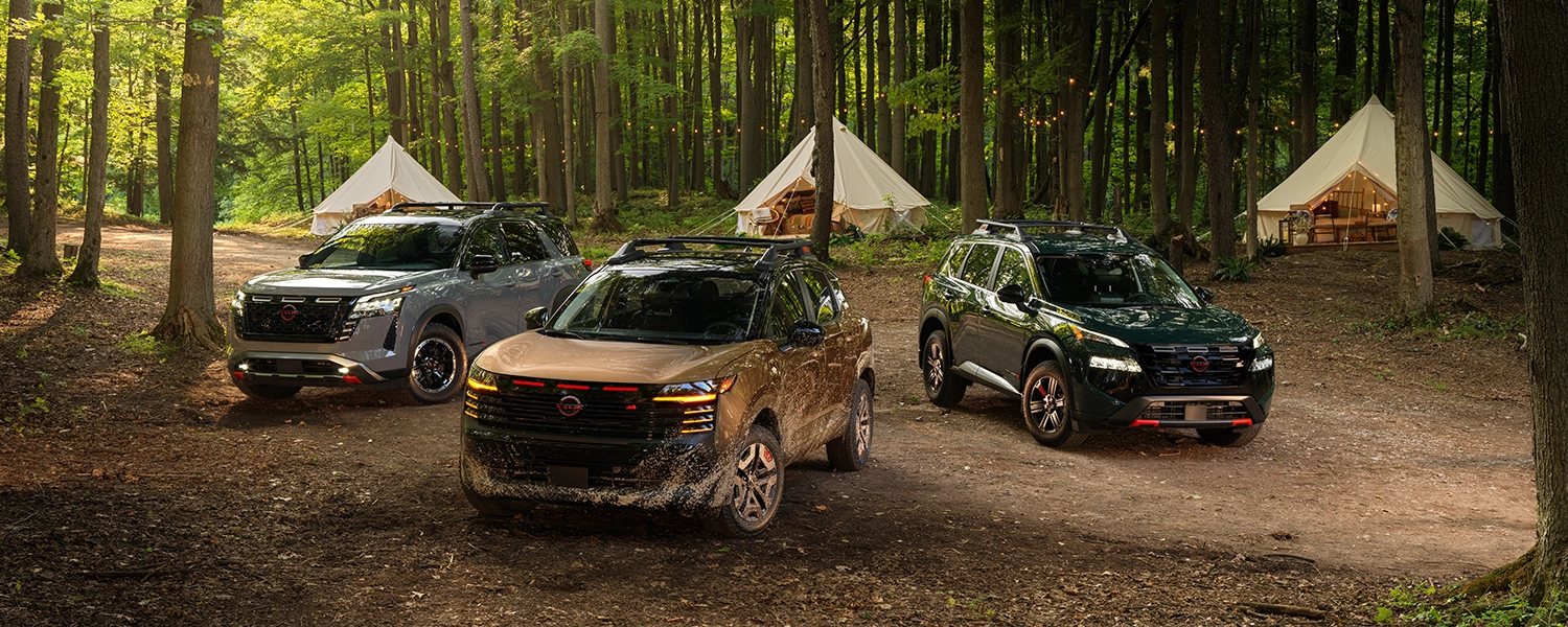 All three Nissan Rock Creek models, from left to right: Nissan Pathfinder, Nissan Kicks and Nissan Rogue, parked in a forest setting.