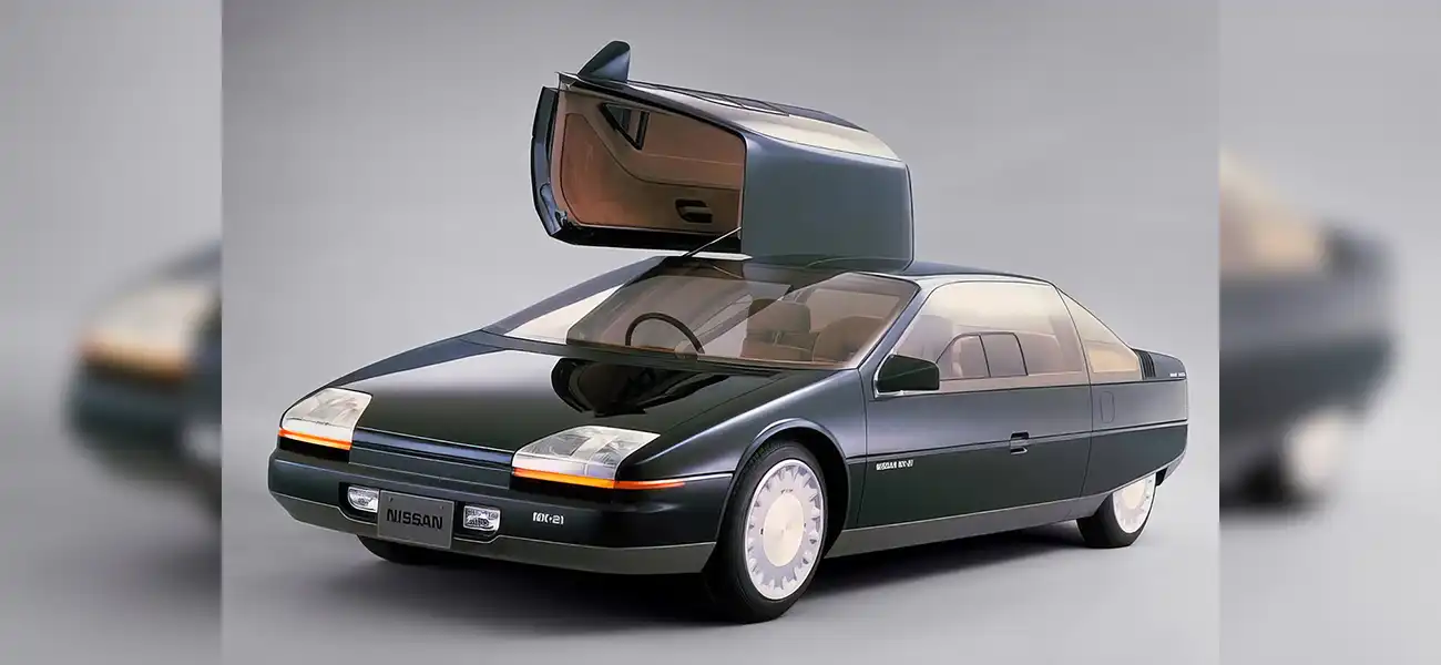 A futuristic black concept car with a door opened upward.