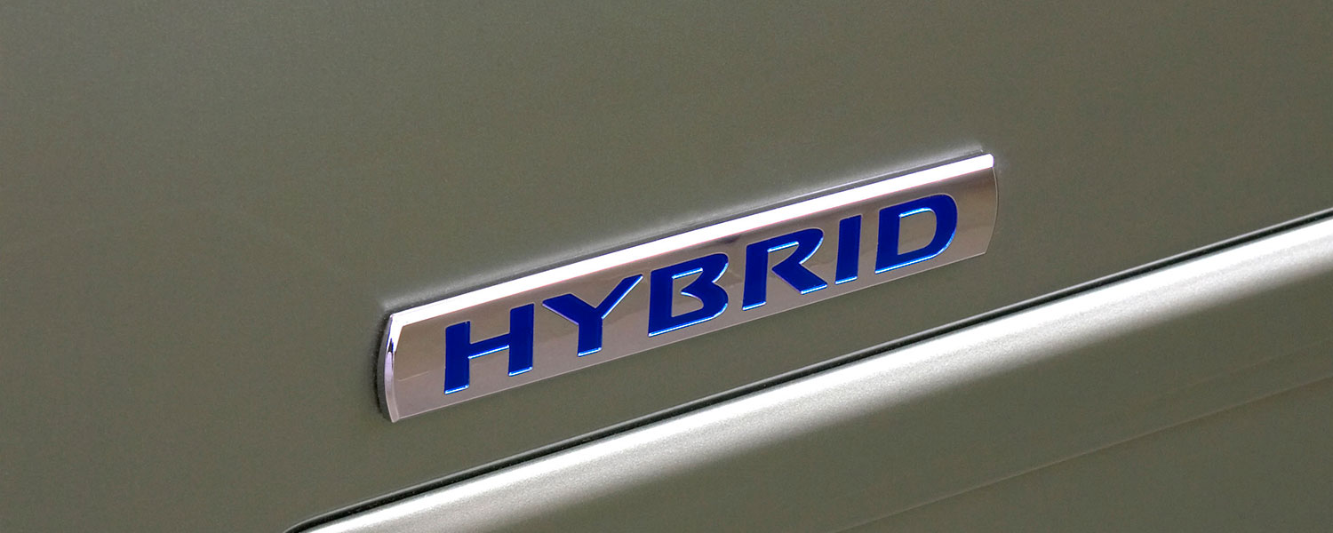 A close up photo of the Hybrid emblem on a 2007 Nissan Altima