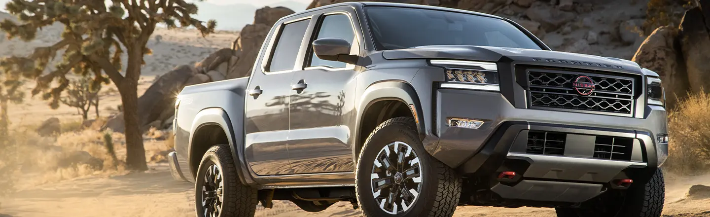A 2022 Nissan Frontier surrounded by rocky terrain.