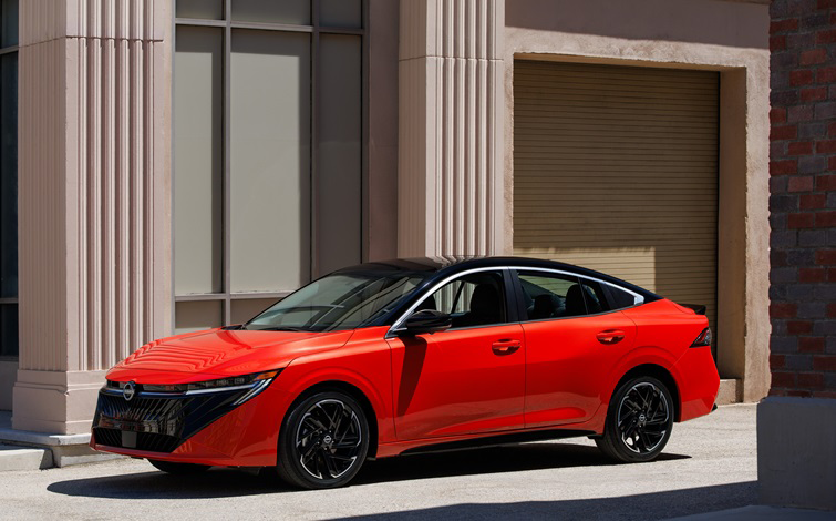 Angled profile view of the 2026 Nissan Sentra parked in front of a city building.