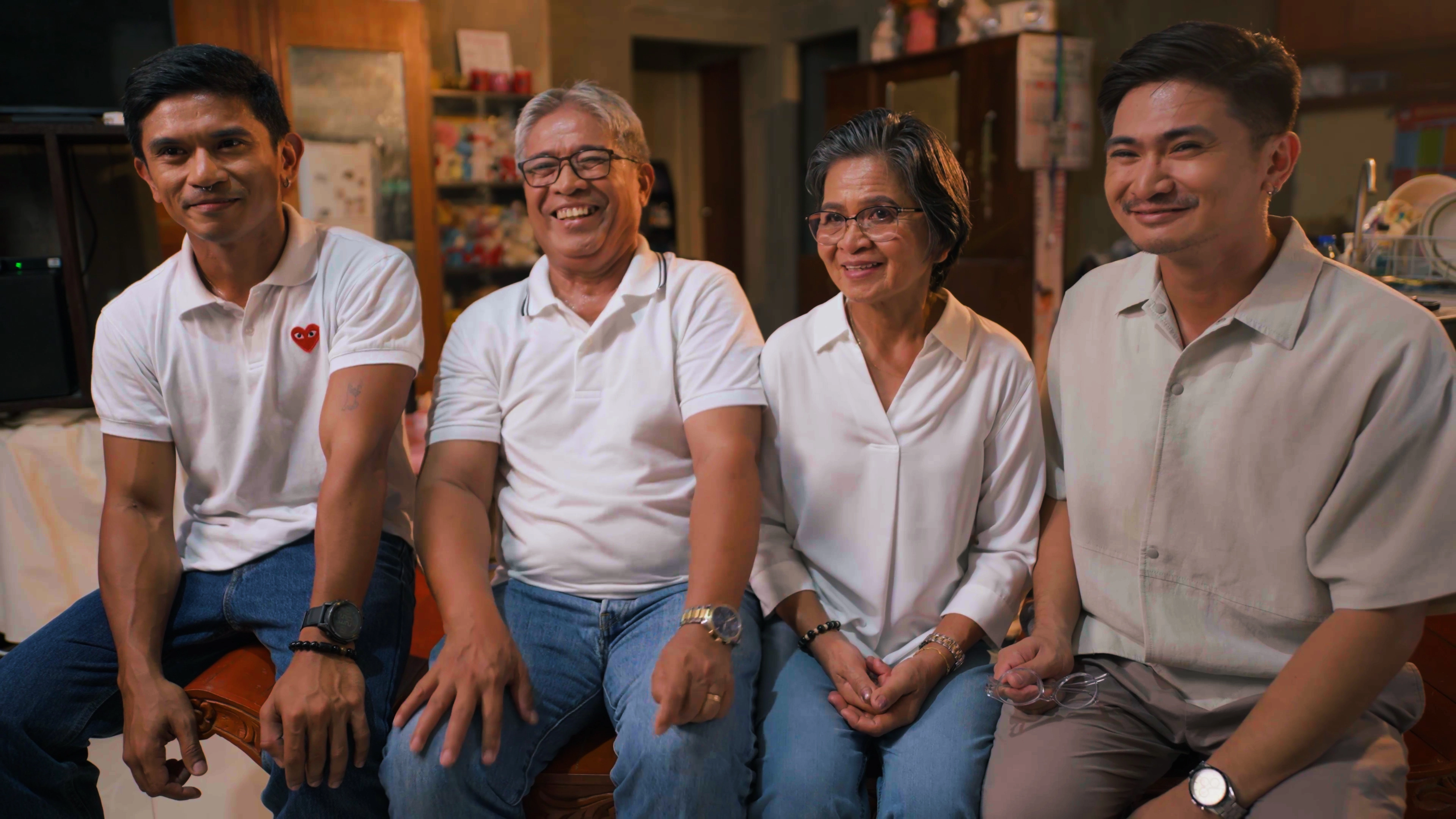 A photo of the Miscala family sitting together in their home