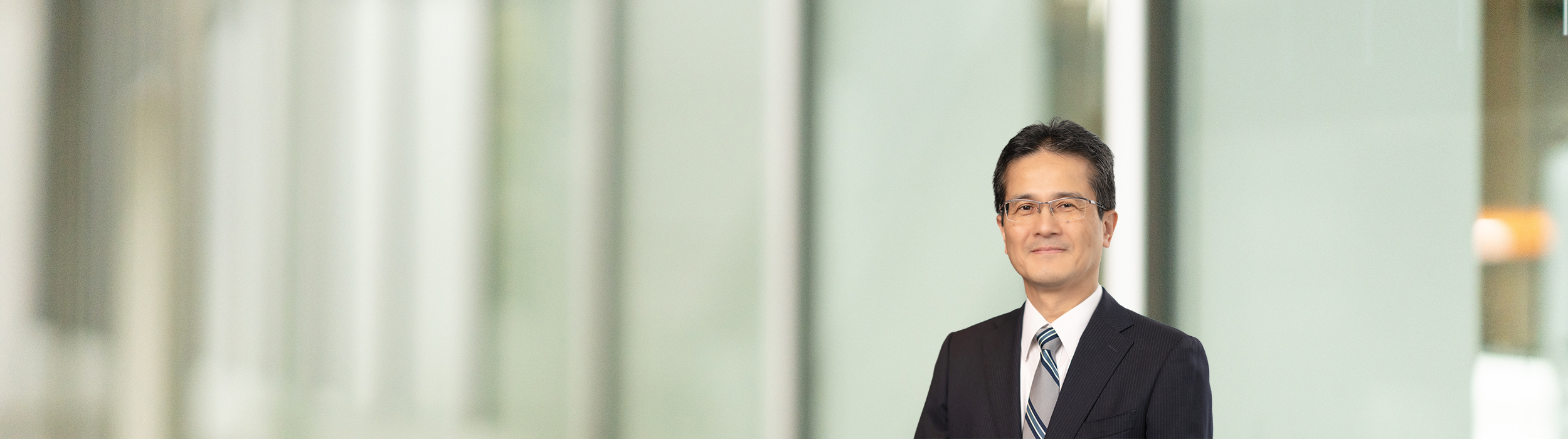 Portrait of Teiji Hirata (suit, tie and NISSAN corporate pin) (smiling)