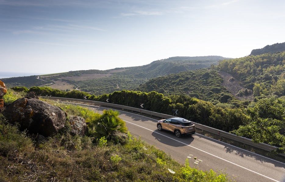 Nissan driving on a mountainside road