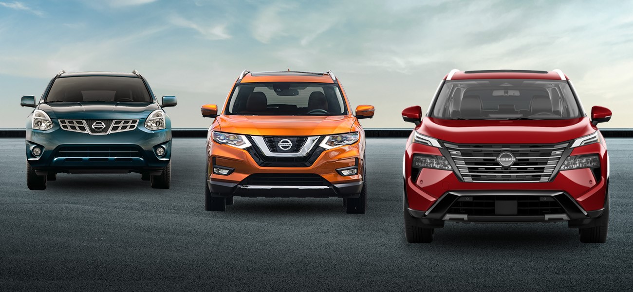 A blue first generation, orange second generation and red third generation Nissan rogue all parked in a line.