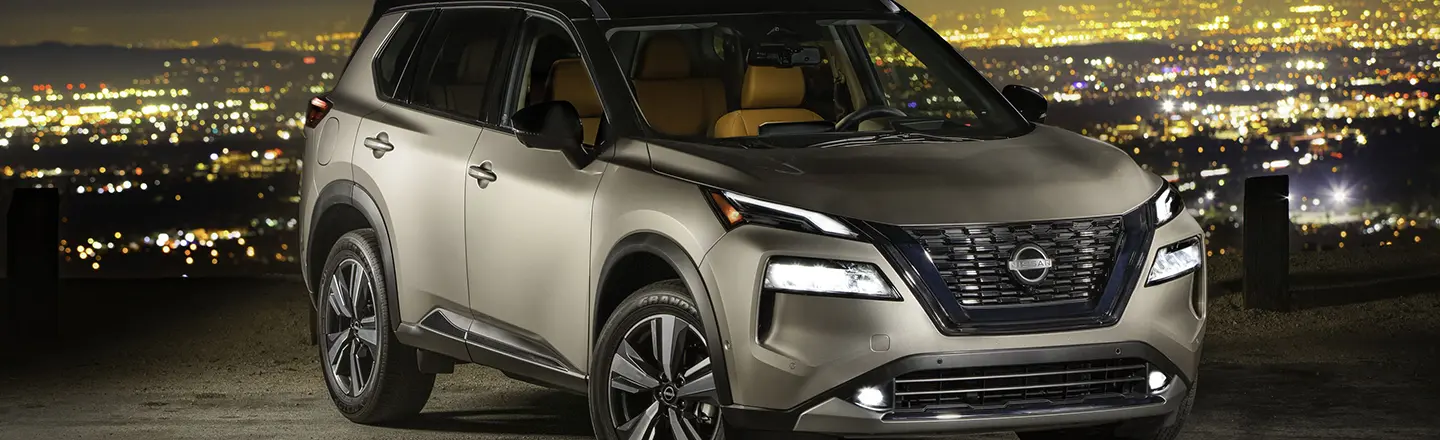 Front right view of the 2022 Nissan Rogue parked at night.
