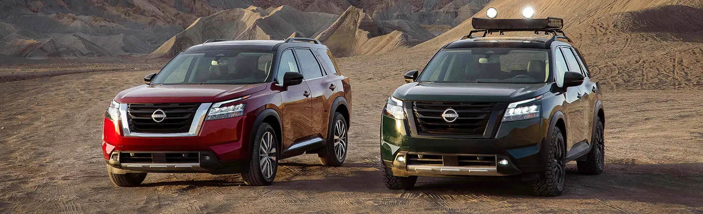Two 2020 Nissan Pathfinders are parked in the desert.