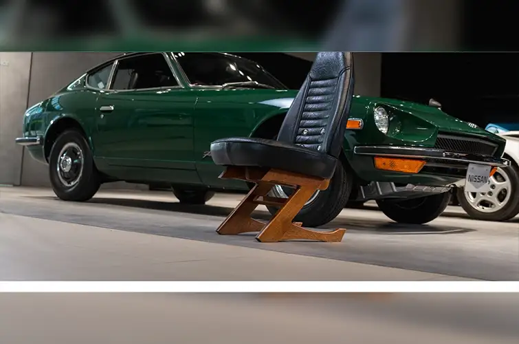 A green car chair in front of a green Nissan car.