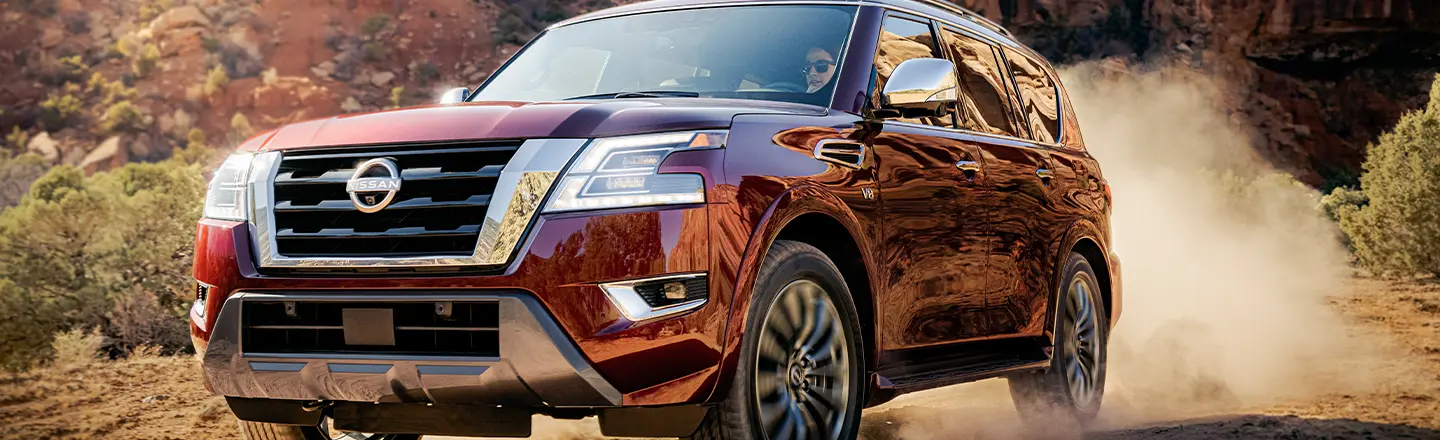 Front left view of a 2022 Nissan Armada driving off-road.