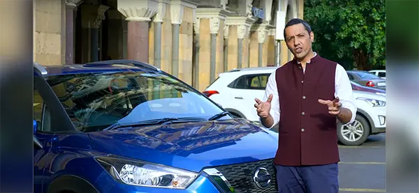 Celebrity chef Aditya Bal standing in front of a Nissan KICK