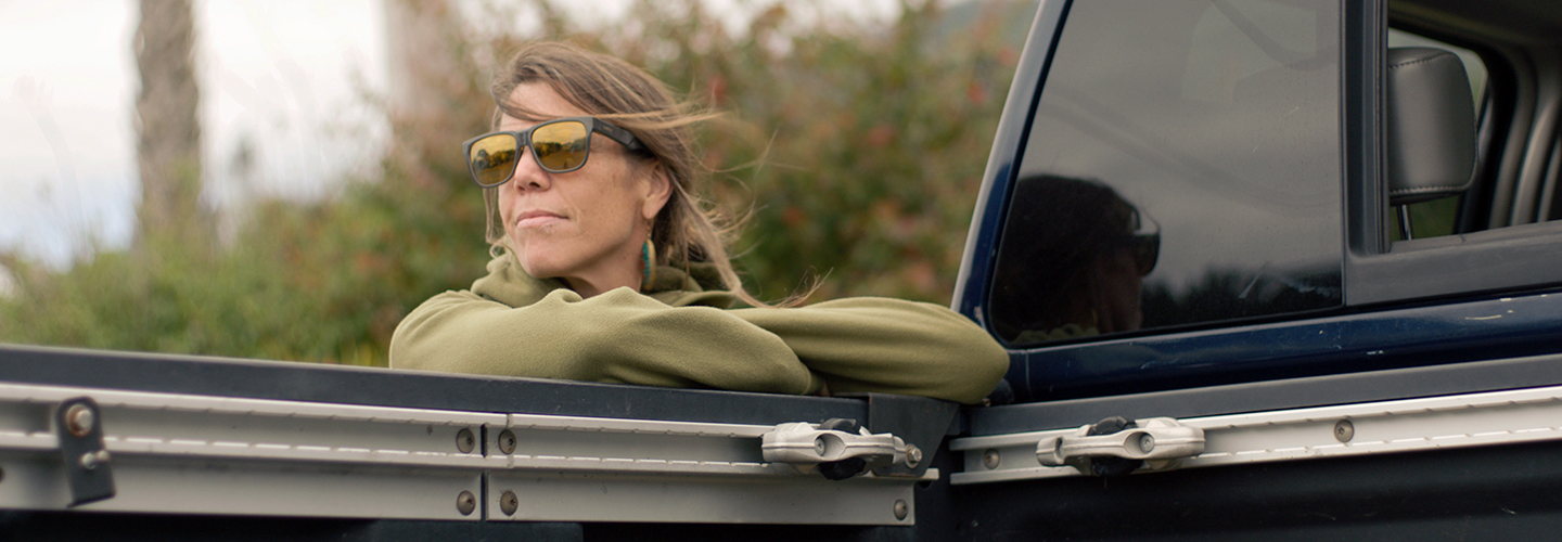 Jamie Schou leaning on the trunk of her Titan.