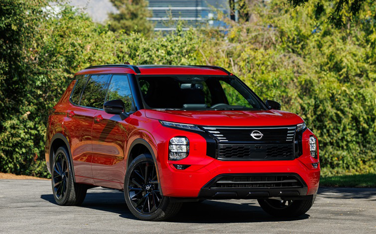 Front right 3/4 view of a red 2026 Nissan Rogue Plug-in Hybrid parked on asphalt.
