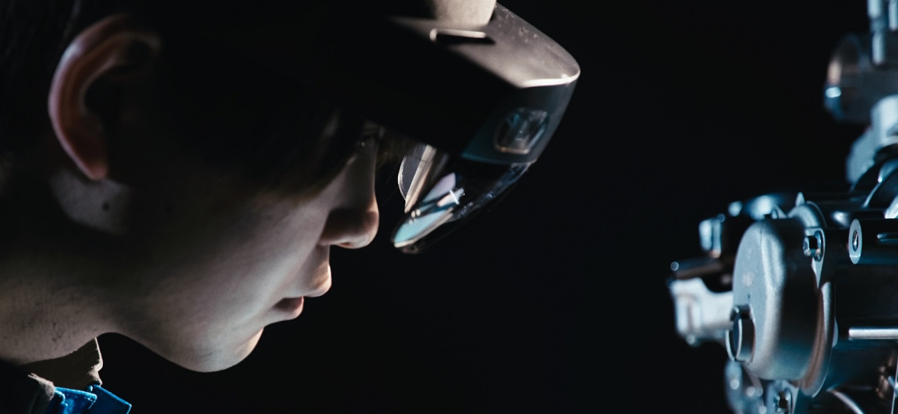 Person wearing VR goggles looking towards equipment