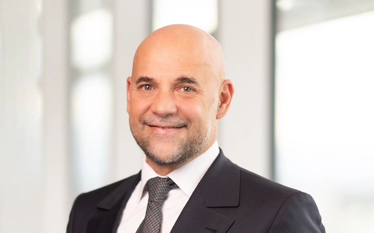Portrait of Guillaume Cartier (suit, tie and NISSAN corporate pin)