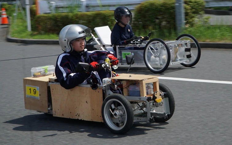 手作りのエコカーで走行する学生たちの競技風景