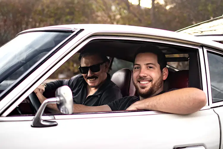 Lukas Cotugno and his uncle posing in a white Nissan Z-Car