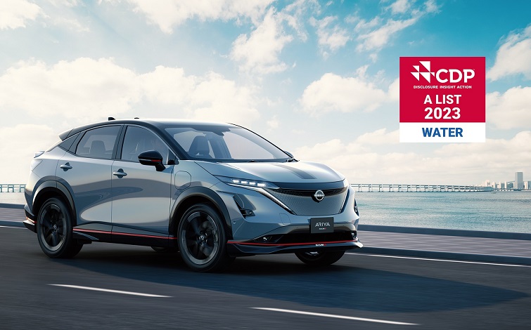 Driving Nissan Ariya NISMO on the bridge beside canal with red logo of CDP A list 2023 WATER