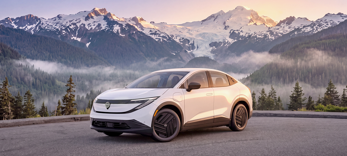 2027 Nissan LEAF S with mountains and forest landscape in the background.