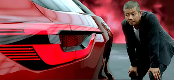 Man admiring the contour of the Nissan Magnite concept's rear hatch