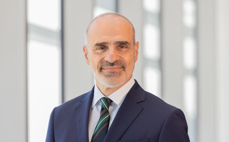 Portrait of George Leondis (suit, tie and NISSAN corporate pin)