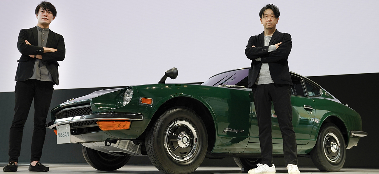 Naoyuki Ohkoshi and Takuya Yamashita pausing in front of a green Nissan Z.