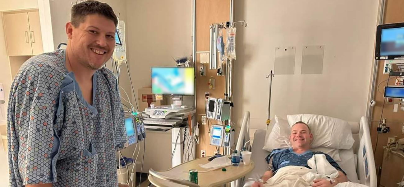 Josh Bredeson and Josh Shaffer in the hospital room smiling.