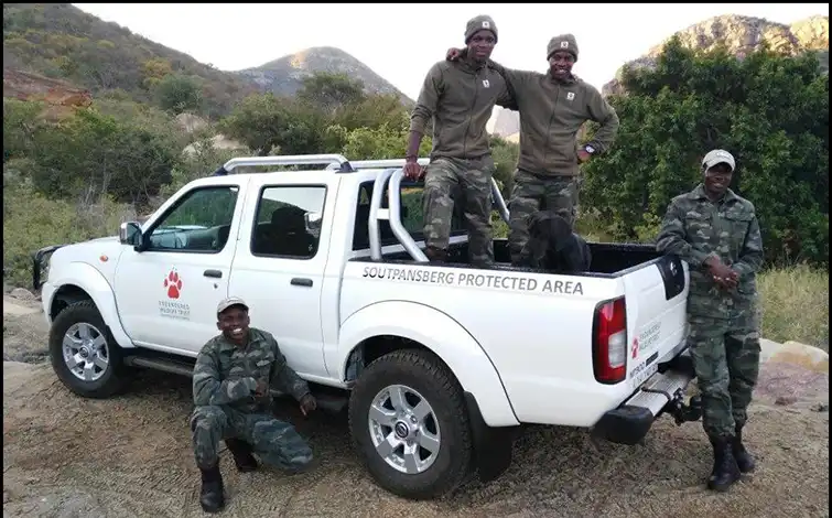 Endangered Wildlife Trust employees posing on a Nissan truck