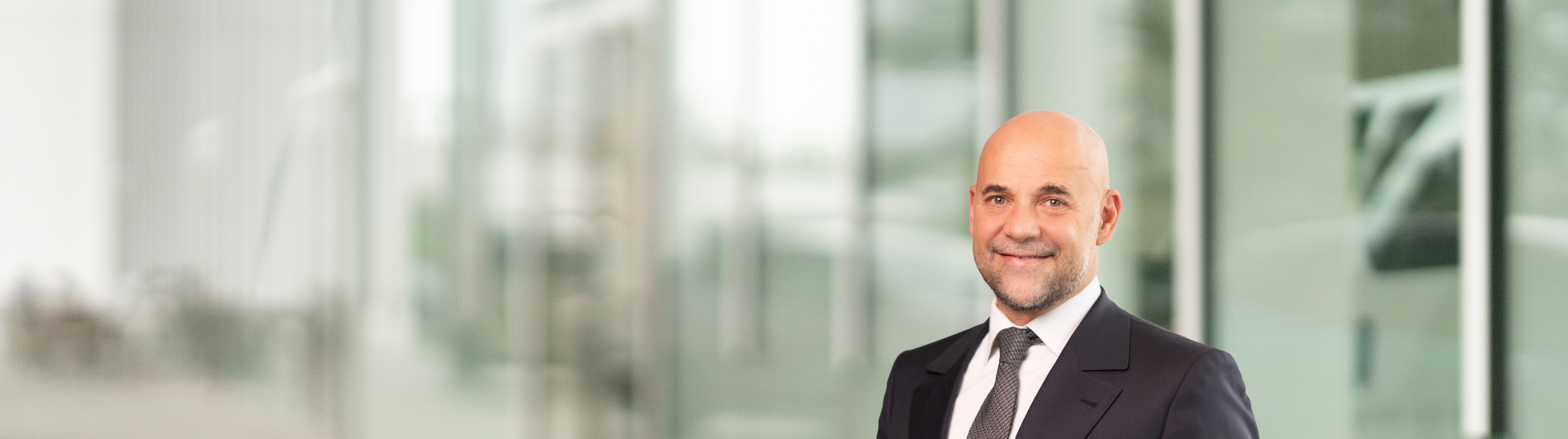 Portrait of Guillaume Cartier (suit, tie and NISSAN corporate pin)