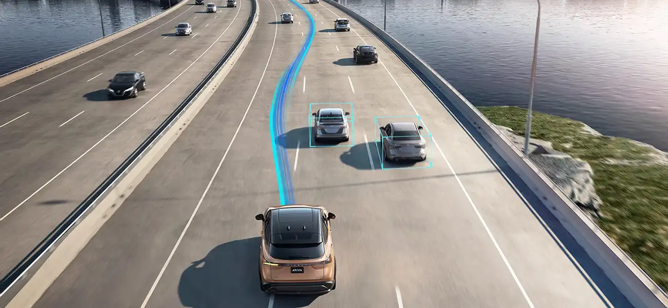 Multiple of cars driving on a freeway with a copper Ariya.