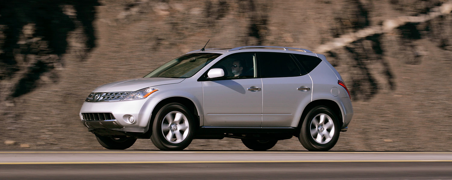 A silver Nissan Murano driving on the road