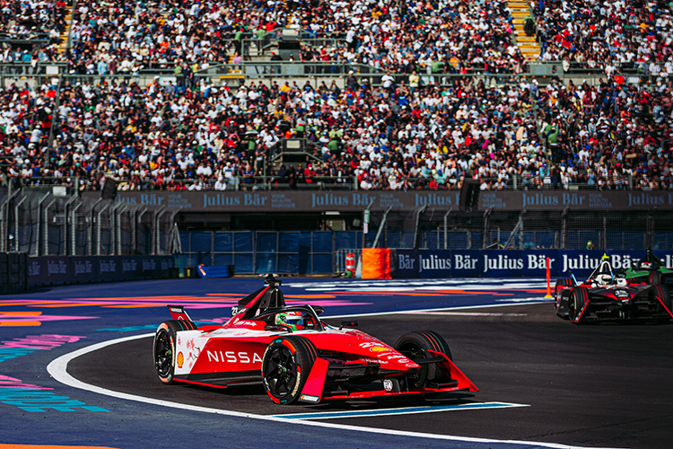Red race car turning corner on track